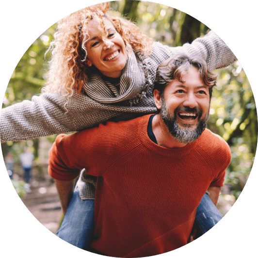 Happy Couple Woman Riding Man's Back